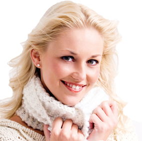 Smiling blonde woman with winter white sweater and scarf