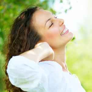 Beautiful brunette woman smiling in the spring sunshine